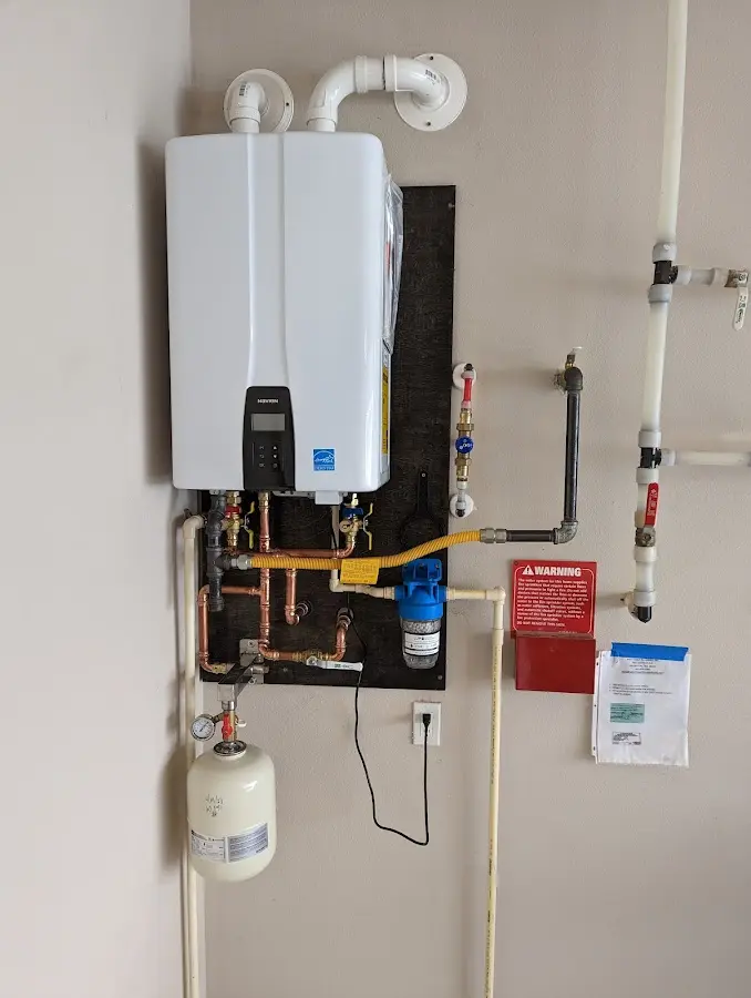 Professional plumber installing copper piping in a Badger home